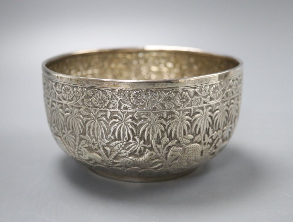 An Indian white metal sugar bowl decorated with a continuous frieze of animals in the jungle, diameter 11cm